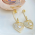 Brinco Dourado Pingente Corao Cravejado